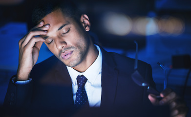 Image showing Night, stress and headache of a businessman working overtime or late in dark office for 404 report, IT coding or software deadline. Tired, frustrated or sad corporate information technology manager