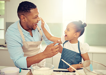 Image showing Father, playing and girl baking in family kitchen with flour, food and dough while learning to bake cake. Happy dad teaching playful daughter cookies recipe with excited young kid helping at home