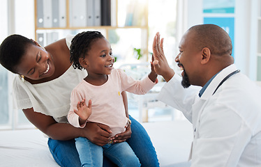 Image showing Healthcare, mother and girl gives doctor high five in a doctors office. Medical insurance, healthy child development and consulting in a doctors office. Black woman, daughter and pediatrician smiling