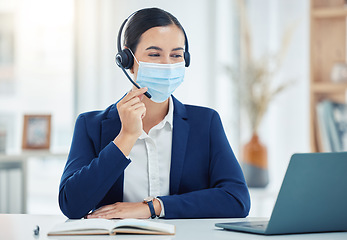 Image showing Call center agent with covid giving online service with laptop, working in telemarketing and helping people with communication on pc work office. Latino customer support worker consulting with mask