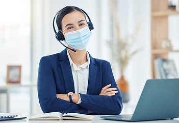 Image showing Covid, telemarketing and woman with mask portrait at a corporate work building in the pandemic. Help desk worker at table with medical face protection from coronavirus transmission with staff.