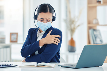 Image showing Call center, shoulder injury and woman at the office in pain holding arm in customer service. Business female in telemarketing suffering with muscle ache from work strain on laptop at the workplace.