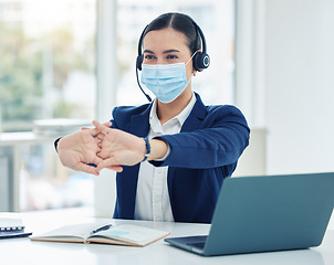 Image showing Call center worker with covid stretching with mask at work and woman resting while consulting with people online on a laptop. Tired customer service worker, consultant and employee working in sales