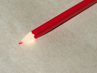 Image showing Red pencil over paper