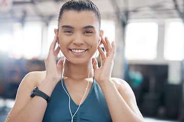 Image showing Health, fitness and music by a woman at gym, streaming playlist while prepare for exercise or cardio workout. Portrait of a fit athlete enjoying a motivation podcast online, excited to begin warm up