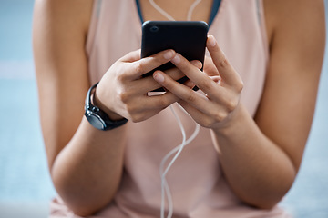Image showing Fitness app, phone and communication while typing on phone in sportswear to track progress on smart device with fast network. Close up hands of a woman listening to music or podcast during training