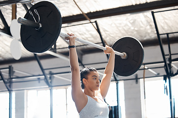 Image showing Woman athlete, fitness and workout in a gym while lifting heavy weight while a cardio exercise. Health, wellness or motivation in training with a strong, healthy and powerful woman with weightlifting