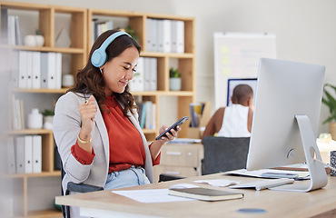 Image showing Employee, on phone and headphones in office listening to music while browsing social media. Happy and excited business woman with smile receives good news on her mobile device in corporate building