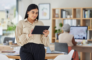 Image showing Business woman, office and working on digital tablet in the workplace with colleague in the background. Happy employee busy with online marketing on touchscreen in research, development and design.