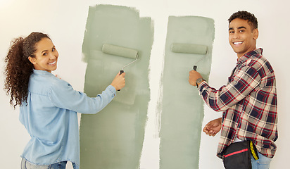 Image showing Portrait of happy couple painting room or interior house renovation and home or property design project with smile, white wall background. New home or apartment and happy painter people and DIY paint