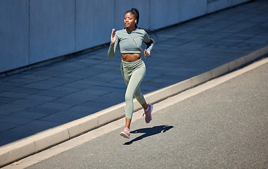 Image showing City street, fitness and running woman with earphones listening to music or motivation audio for health workout with outdoor mockup. Black woman jogging or exercise training with a wellness podcast