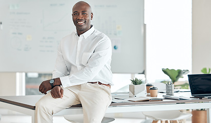 Image showing Black business man, leader and office in happy, proud and confident success for company goals in the corporate workplace. African guy in success at desk with smile in management and leadership work