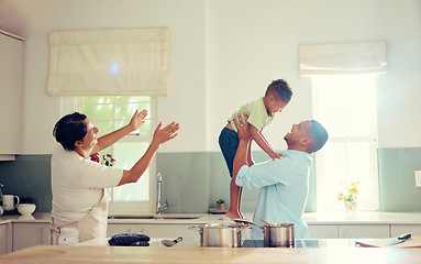 Image showing Family, father and son in the kitchen with happy, playful and joy time at home smiling in happiness. Parents in care, love and fun with child together in a house playing with smile and funny moments.