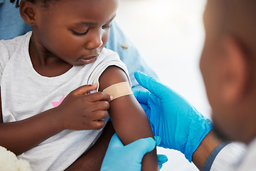 Image showing Doctor, healthcare expert and medical worker with plaster on arm of sick child after covid vaccine, help with medical emergency and consulting with patient at hospital. Girl with bandage after injury