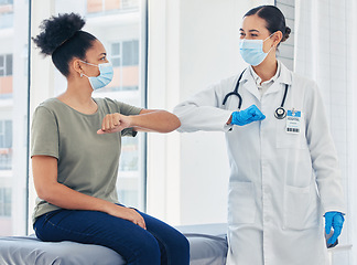 Image showing Doctor, covid and greeting medical healthcare expert with patient in safe elbow with masks in a hospital. Happy women following safety social distance rules to prevent the spread of virus at clinic
