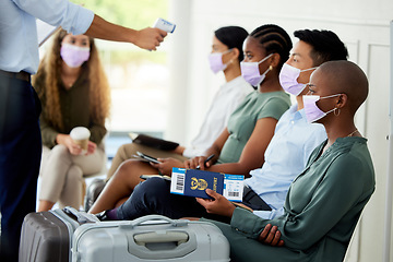 Image showing Covid, travel and airport with security scanning a woman with an infrared thermometer for temperature. Immigration, restrictions and passport with a female passenger getting ready to board a flight