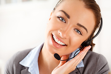 Image showing Call center, contact us and business woman in customer support with happy face and smile at the office. Portrait of a female telemarketing employee, consultant or agent in happiness with headset.