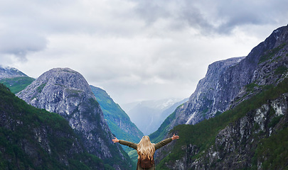 Image showing Travel adventure woman celebrates arms raised at view of majestic glacial valley on exploration discover beautiful earth