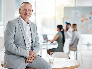 Image showing Portrait, happy business man or ceo in office on table for motivation, inspiration and vision with a smile. Boss, leader or executive with plan for innovation, strategy and future success planning.