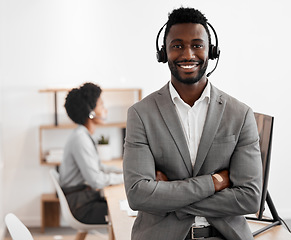 Image showing Call center, customer service and crm consultant wearing headset and looking happy in telemarketing company. Portrait of confident black man in contact us and sales support department for assistance