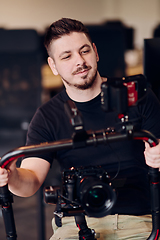 Image showing A professional videographer using modern equipment to capture compelling visuals, showcasing expertise and creativity in the art of video production.