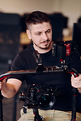 Image showing A professional videographer using modern equipment to capture compelling visuals, showcasing expertise and creativity in the art of video production.