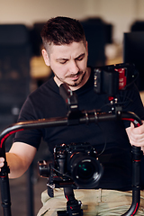 Image showing A professional videographer using modern equipment to capture compelling visuals, showcasing expertise and creativity in the art of video production.