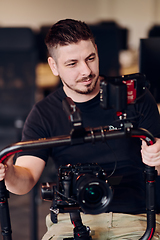 Image showing A professional videographer using modern equipment to capture compelling visuals, showcasing expertise and creativity in the art of video production.