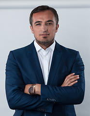 Image showing Young beautiful focused european businessman. Front view of man with dark hair clothing casual business formal jacket Isolated on gray background