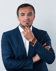 Image showing Young beautiful focused european businessman. Front view of man with dark hair clothing casual business formal jacket Isolated on gray background