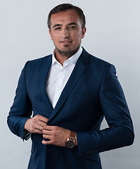 Image showing Young beautiful focused european businessman. Front view of man with dark hair clothing casual business formal jacket Isolated on gray background