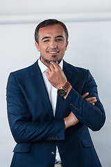 Image showing Young beautiful focused european businessman. Front view of man with dark hair clothing casual business formal jacket Isolated on gray background