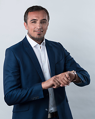 Image showing Young beautiful focused european businessman. Front view of man with dark hair clothing casual business formal jacket Isolated on gray background