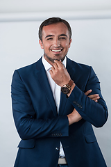 Image showing Young beautiful focused european businessman. Front view of man with dark hair clothing casual business formal jacket Isolated on gray background