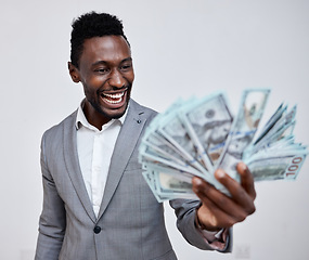 Image showing Happy black man with dollars, money or winner isolated on a grey mockup background. Finance, wealth and excited rich African person with a stack of bills, lotto or financial investment business deal
