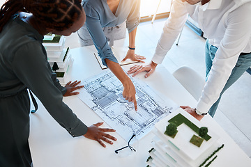 Image showing Architect, team and planning building blueprint in office for coworkers to look at before construction. Workers looking at designs and scale model for future architecture in corporate work setting.