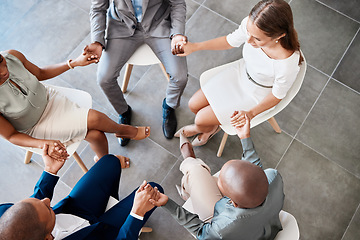 Image showing Diversity, support and collaboration of business people holding hands above in trust for company success. Diverse group of corporate workers in a circle of unity for a meeting together at the office