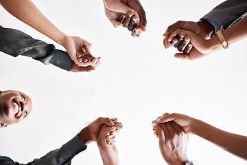 Image showing Diversity, support and collaboration of business people holding hands below in trust for company success. Team of corporate workers in a circle of success in a meeting together at a corporate company