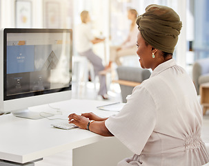 Image showing Administration, corporate and business woman typing on computer at her desk in digital marketing company office building. Advertising, branding and vision with black woman working at a digital agency