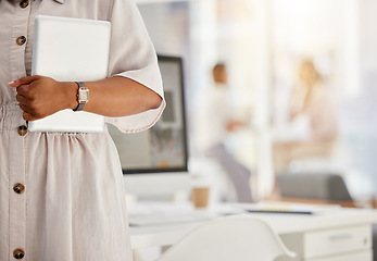 Image showing Tablet, technology and internet with the hand of a business woman holding a wireless device in her office with colleagues in the background. Wifi, communication and networking with modern tech