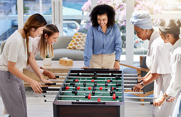 Image showing Table football or soccer as office women play a fun foosball game together on their lunch break at work. Entertainment, happy and female friends in a friendly match competition to enjoy free time