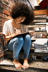 Image showing Learning, studying and black woman writing notes in a book, notebook or textbook on house steps. African girl, education and student with notepad, paper or books with a pen or pencil at home.