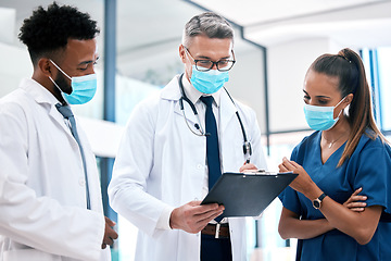 Image showing Covid policy, paperwork and team of doctors in face mask in conversation, discussion or talking of medical healthcare insurance. Communication, diversity and staff with nurse and covid 19 checklist