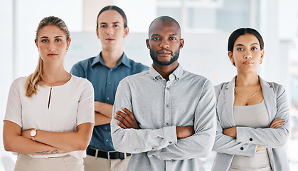 Image showing Motivation, arms crossed and serious with business people standing in corporate company building together. Innovation teamwork and goals with employees in conference, workshop or meeting