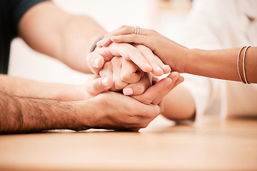 Image showing Support, care and family holding hands together at table to show empathy, love and hope. Closeup of connection, trust and friendship in community rehab group showing compassion and gratitude.