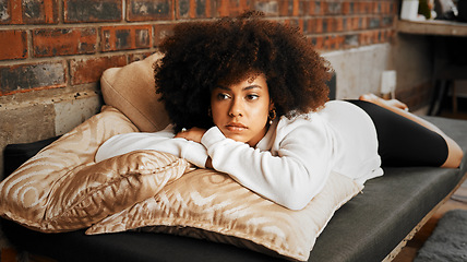 Image showing Sad, tired and depressed African woman thinking with burnout, anxiety and depression on the sofa in the living room in home. Girl with mental health problem with idea, in fear and trauma in house