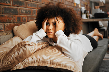 Image showing Depressed, sad and frustrated African woman thinking of idea with anxiety, problem with mental health and depression on the sofa in home. Frustrated, fear and tired girl with stress on house couch