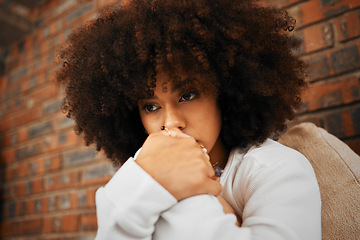Image showing Fear, sad or depression of a young woman sitting with depressed expression or thinking of a problem. Worried and alone african American woman after a bad fail, anxiety or mental health issues