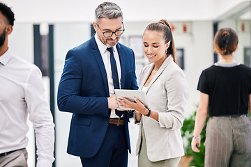 Image showing Business people with a digital tablet while talking, planning and brainstorming together at work. Ceo, leader or boss and young female worker talking after a meeting in a corporate startup office