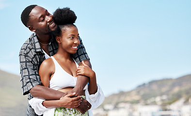 Image showing Young, love and black couple on beach hug while bonding together in blue sky seaside scenery. Happy African American people in joyful relationship embrace each other on peaceful outdoor date.